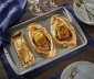 Salmon sitting in a parchment packet on top of a baking sheet